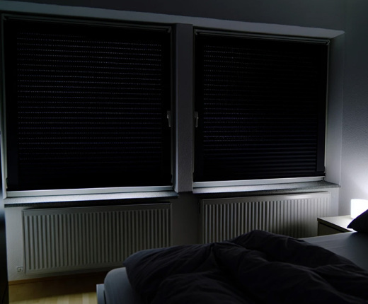 dark blinds blocking light from bedroom windows